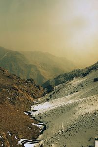 Scenic view of river and mountains against sky