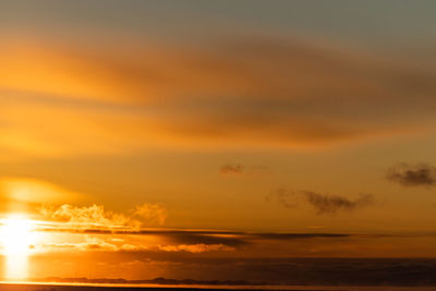 Low angle view of dramatic sky over sea during sunset