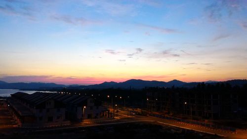 Road leading towards mountains against sky