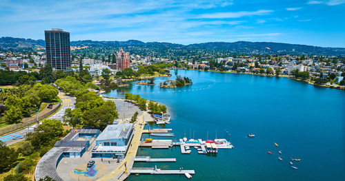 High angle view of cityscape by sea against sky