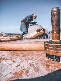 Close-up of rusty metal structure in sea against sky