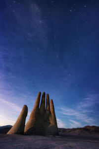 Man against blue sky at night