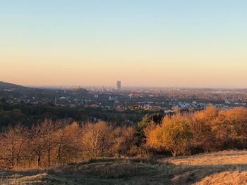 Scenic view of city against sky during sunset