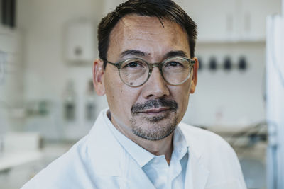 Man wearing eyeglasses standing at laboratory