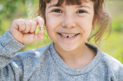 Portrait of smiling girl with broken tooth