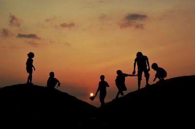 Silhouette people at sunset