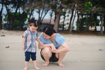 Rear view of mother and daughter