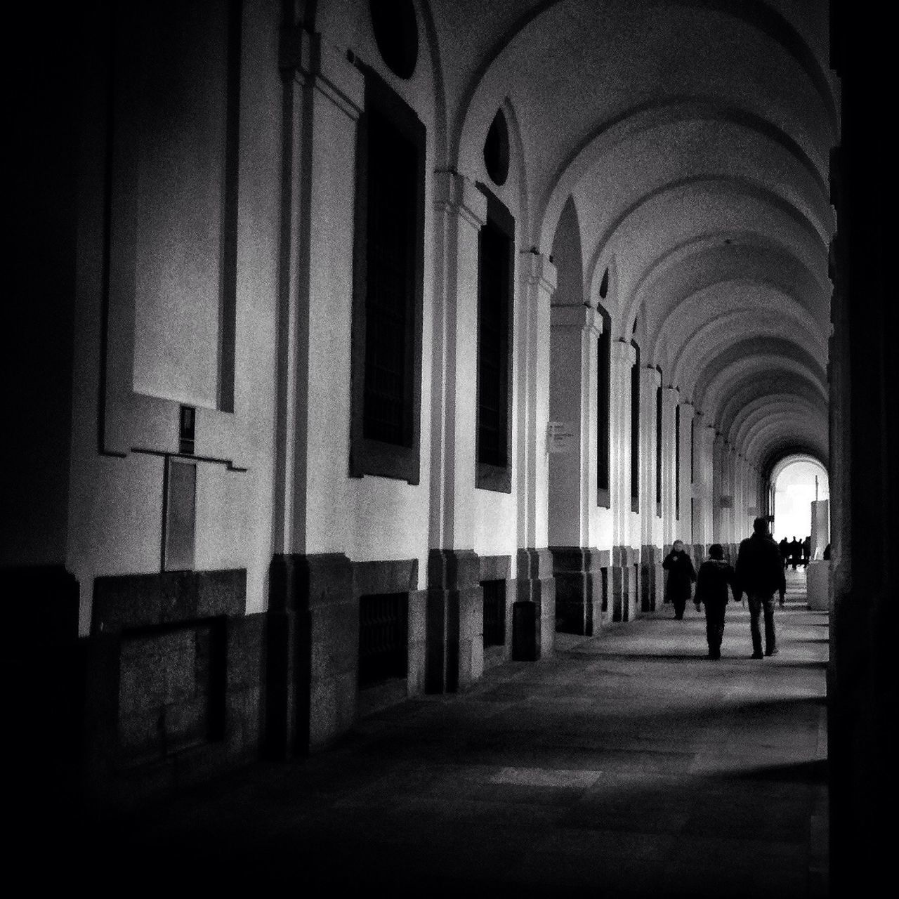 architecture, indoors, walking, arch, built structure, men, full length, the way forward, lifestyles, rear view, person, corridor, tunnel, leisure activity, archway, silhouette, diminishing perspective