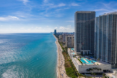 High angle view of buildings by sea against sky