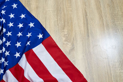 Close-up of american flag on wooden floor