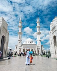 Group of people outside temple against buildings