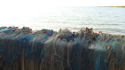 View of fishing net on beach against sky