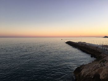 Scenic view of sea against clear sky during sunset