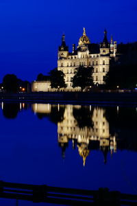 Reflection of building in water at night