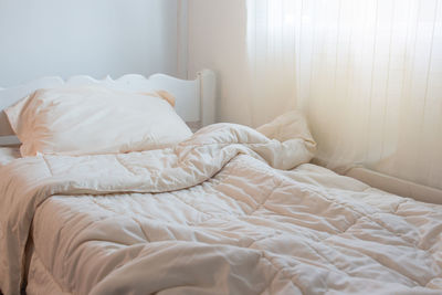 High angle view of crumpled duvet on empty bed at home