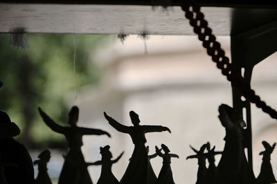 Close-up of silhouette metal fence against sky