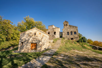 Low angle view of old building against blue sky