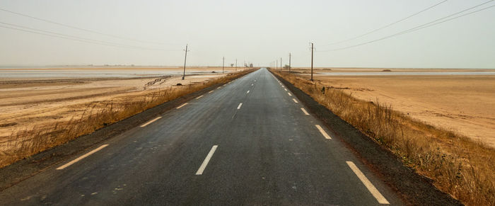 Empty road against clear sky