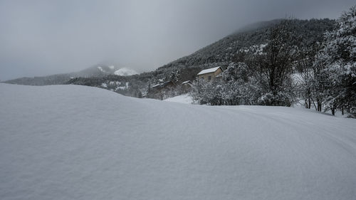 Scenic view of snow covered mountains against clear sky