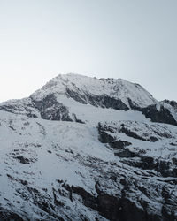 Scenic view of snowcapped mountains against clear sky