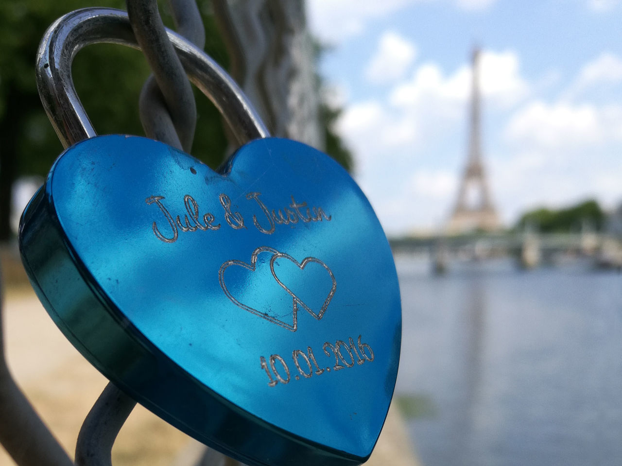 CLOSE-UP OF PADLOCKS ON HEART SHAPE MADE OF METAL