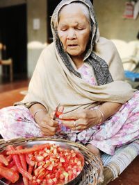 Midsection of woman sitting with ice cream