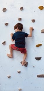 High angle view of boy on floor