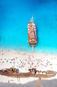 High angle view of umbrellas on beach against blue sky