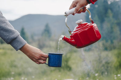 Cropped hand pouring water