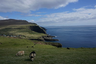 Scenic view of sea against cloudy sky