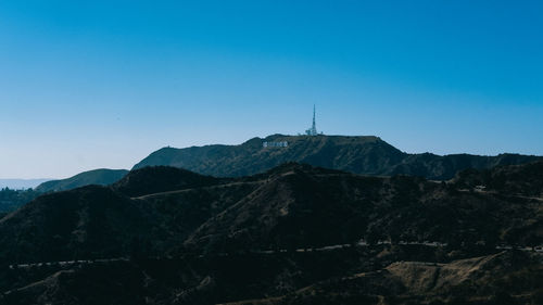 View of mountain range against blue sky