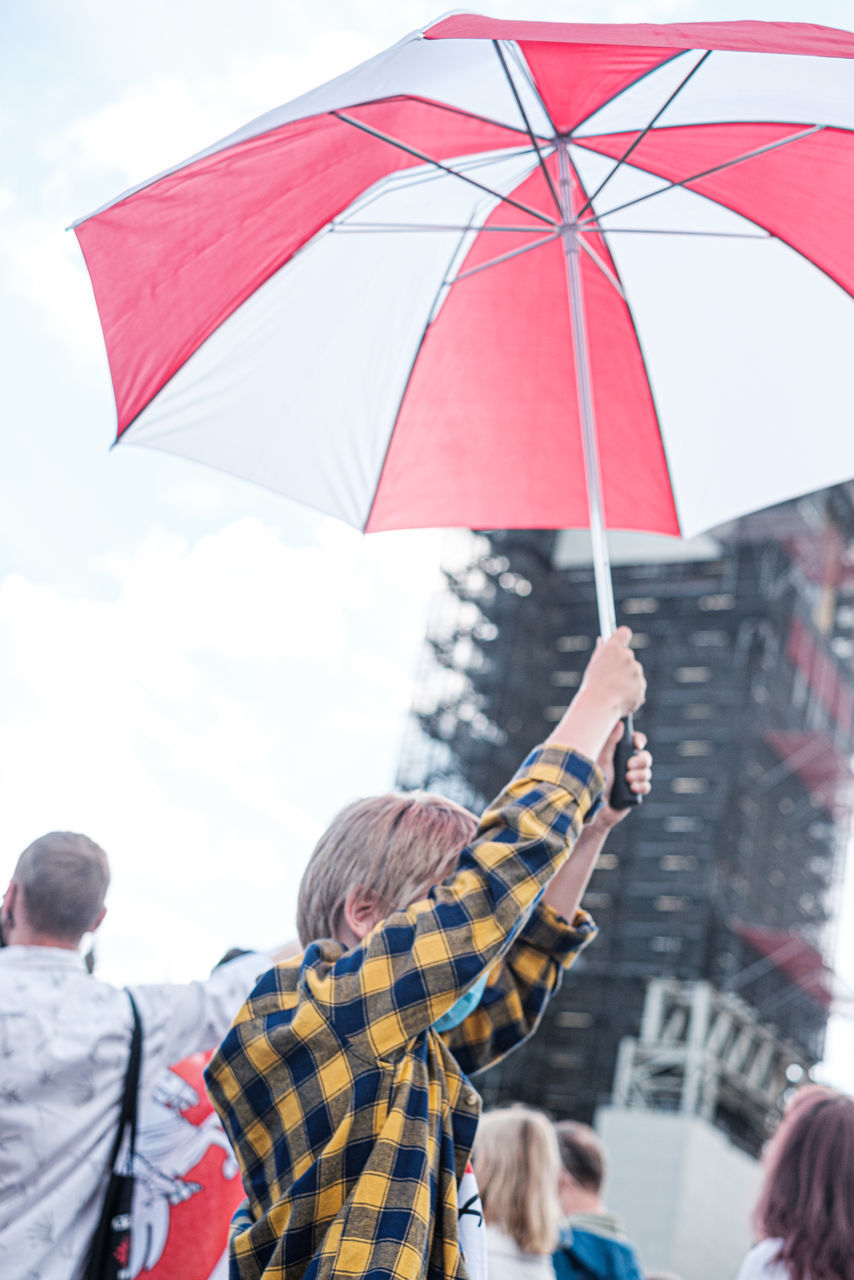 umbrella, protection, rain, security, adult, fashion accessory, group of people, wet, men, holding, city, women, togetherness, nature, day, young adult, outdoors, parasol, crowd, architecture, standing, emotion, group