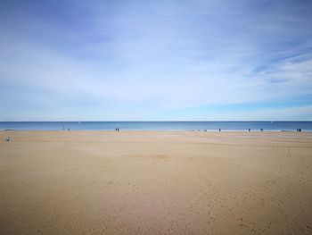 Scenic view of beach against blue sky