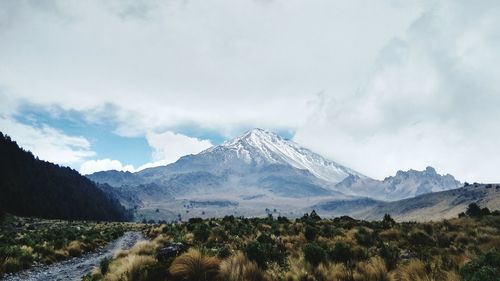 Scenic view of mountains against cloudy sky