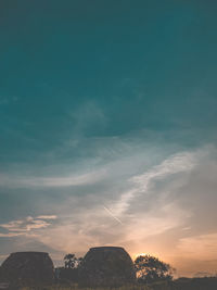 Low angle view of buildings against sky during sunset