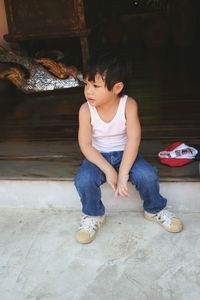 Cute boy sitting on bench