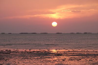 Scenic view of sea against orange sky