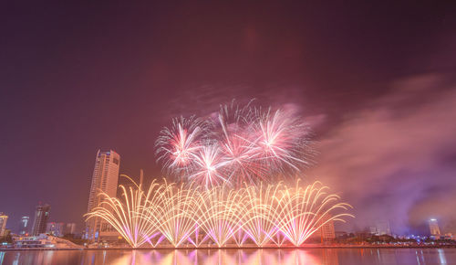 Low angle view of firework display at night