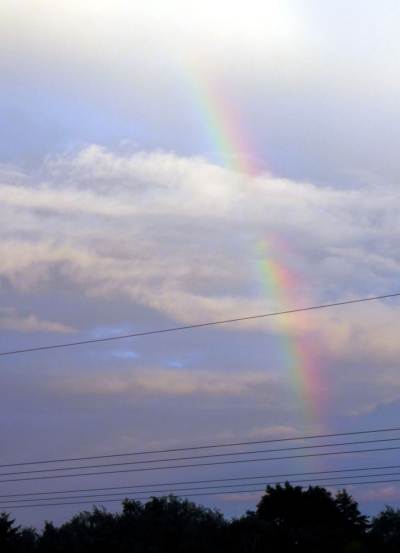 Rainbow at cloudy sky
