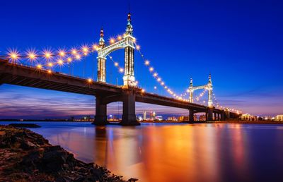 View of bridge over river at night