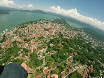 Aerial view of cityscape by sea against sky