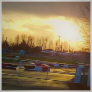 Cars on road at sunset