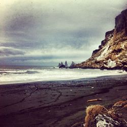 Scenic view of sea against cloudy sky