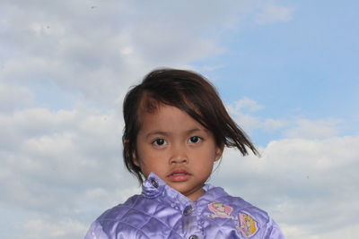 Portrait of cute girl against sky