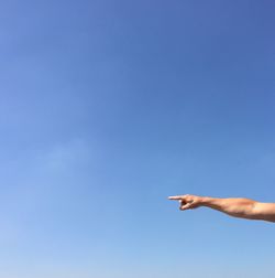 Midsection of man against clear blue sky