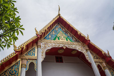 Low angle view of temple and building against sky