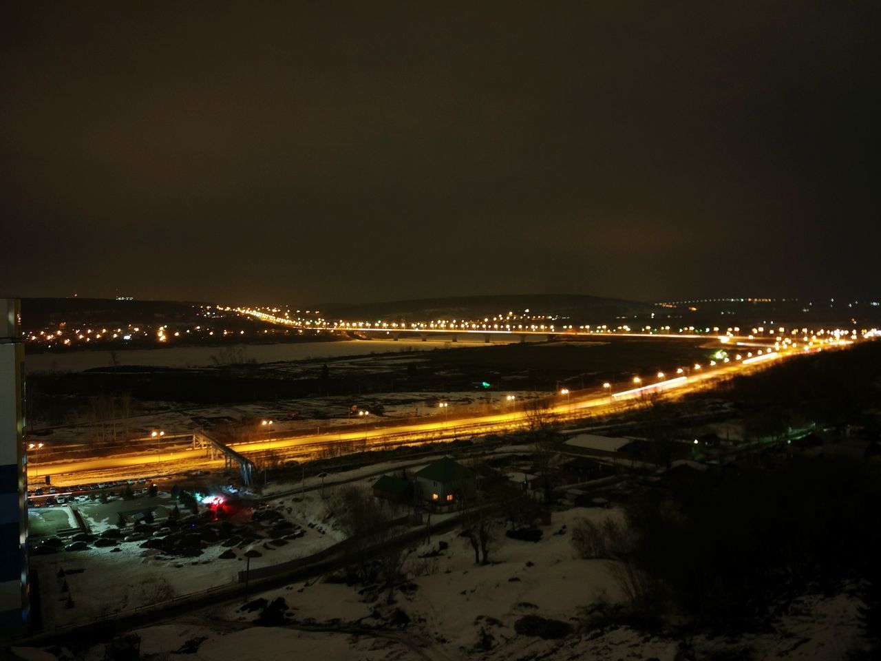 AERIAL VIEW OF ILLUMINATED CITY AT NIGHT