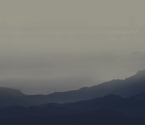 Scenic view of silhouette mountains against sky during sunset