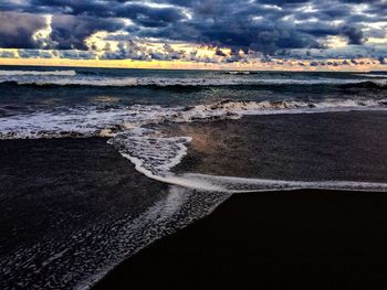 Scenic view of sea against cloudy sky