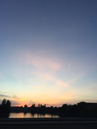 Scenic view of landscape against sky at sunset